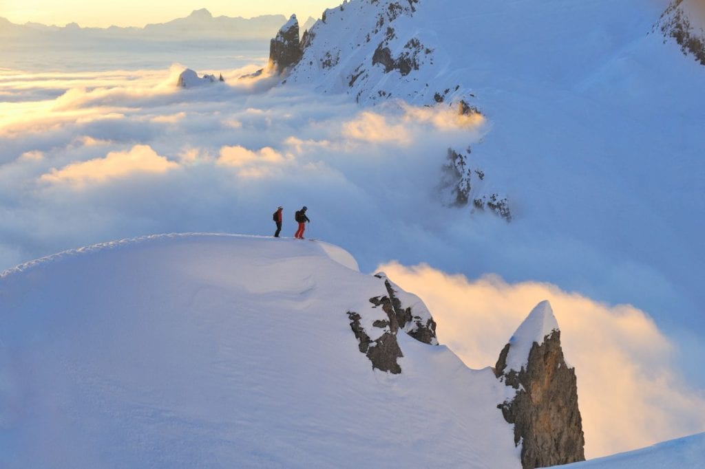 Panoramic view of mountain top with two skiers in Lech, Austria